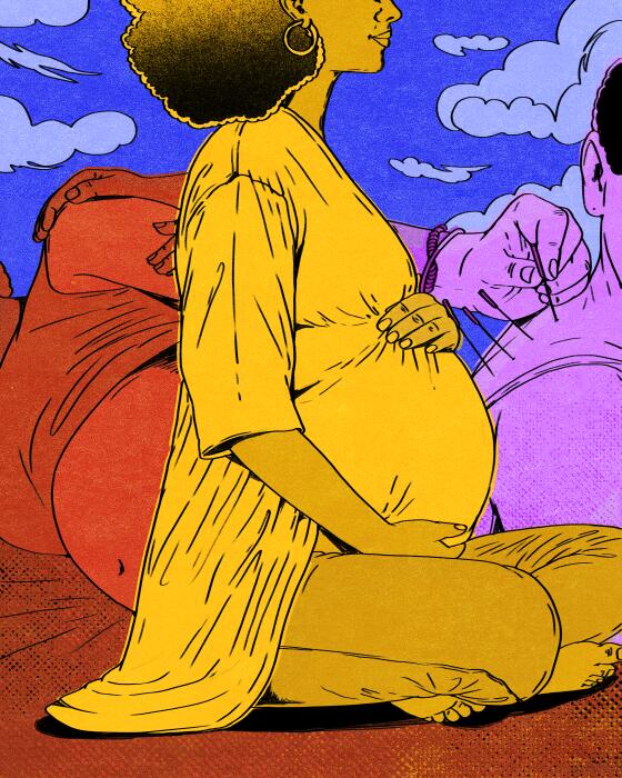 A pregnant woman holds her stomach 