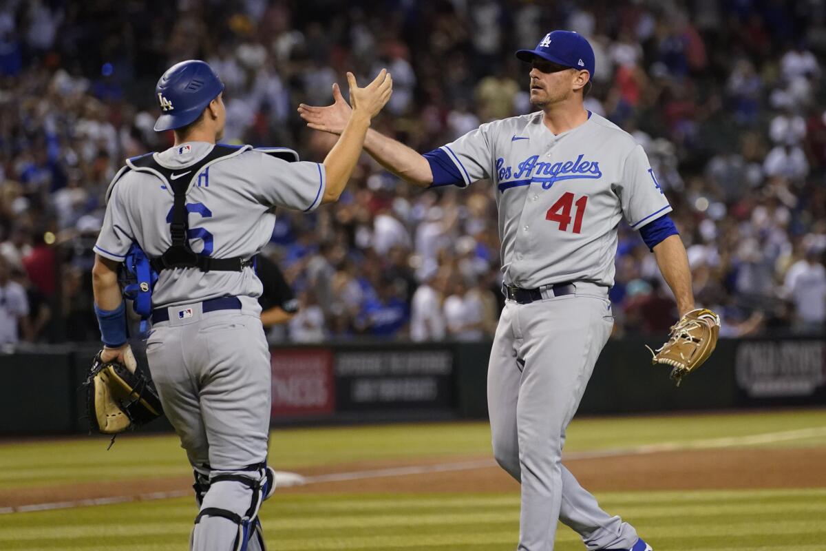 Dodgers reliever Daniel Hudson and catcher Will Smith celebrate after the final out May 28, 2022.