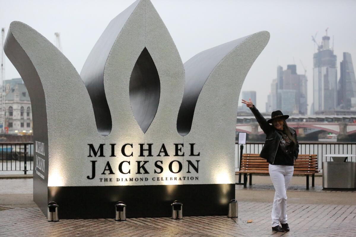A fan celebrates Michael Jackson's birthday at a temporary monument constructed for the star in London.