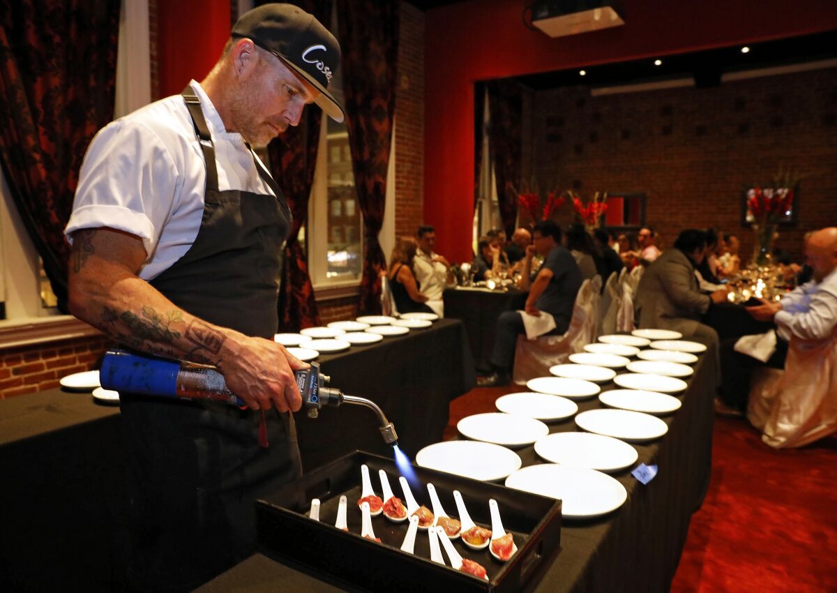 Chef Steve Brown sears a course of Wagyu tri-tip for 40 diners at a $200 Cosecha SD pop-up dinner last month at the Keating Hotel in San Diego's Gaslamp Quarter. Later this year, he'll open a permanent tasting menu-only restaurant in that location.