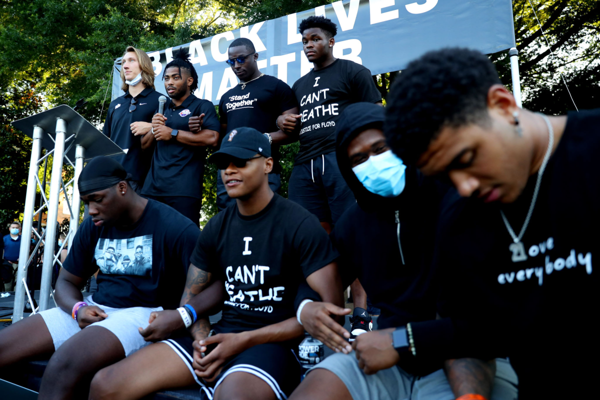 Clemson players, including Trevor Lawrence, top left, pray following the March for Change in Clemson, S.C., in June.