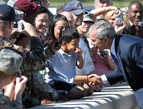 President Bush stops to talks to a boy in the crowd gathered to greet him at Pope Air Force Base in North Carolina.