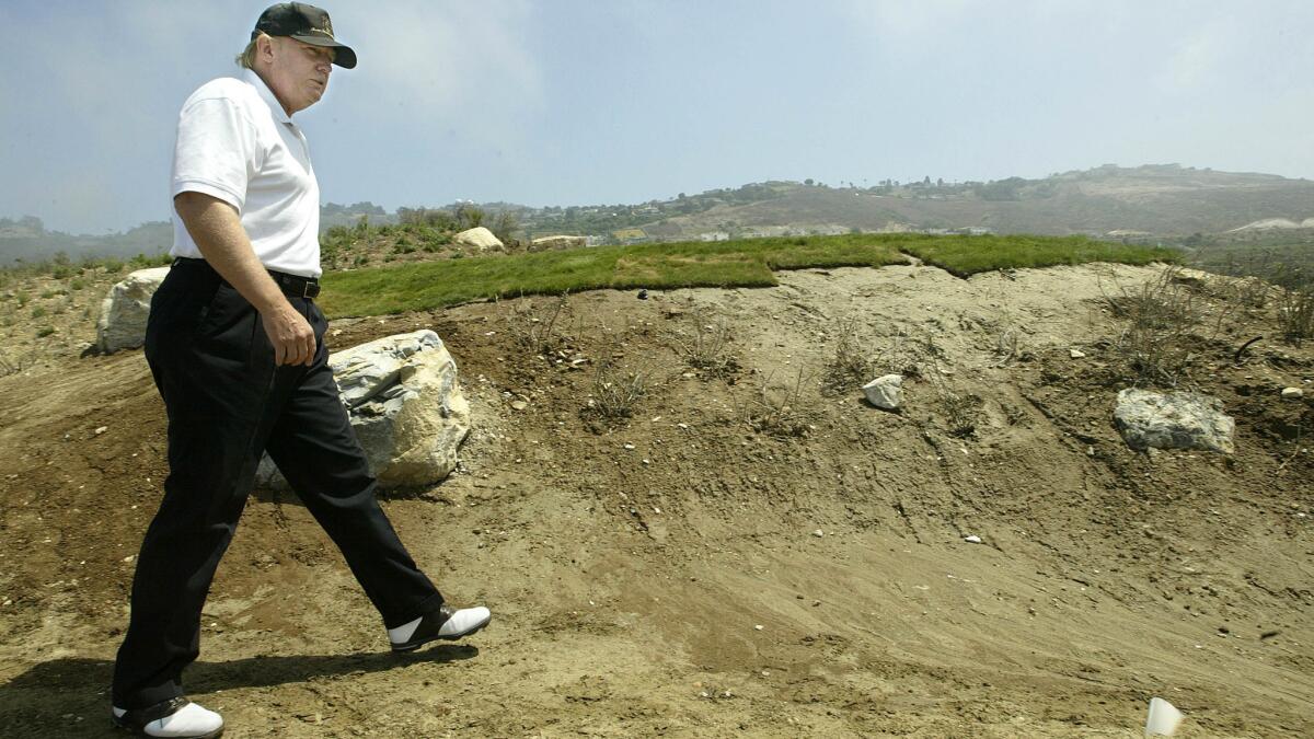Donald Trump walks down an unfinished pathway leading to the 17th tee at Trump National Golf Club, Los Angeles in Rancho Palos Verdes in 2005