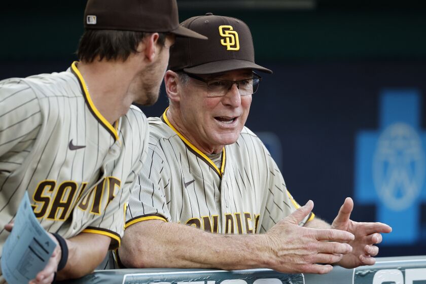 San Diego Padres manager Bob Melvin, right, chats with a Wil Myers, left, before a baseball game against the Kansas City Royals in Kansas City, Mo., Friday, Aug. 26, 2022. (AP Photo/Colin E. Braley)