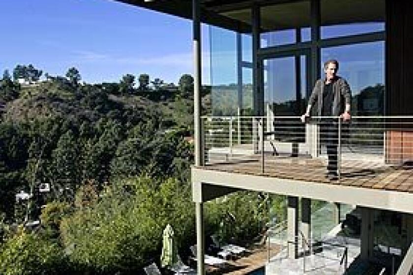 Greta Magnusson Grossman built this 1948 house in Beverly Hills as a quietly dramatic showcase of her skills as an architect and designer of interiors, furniture and lighting. Though she worked in the shadows of midcentury contemporaries such as Rudolph Schindler and Richard Neutra, Grossman maintains a following 10 years after her death — including designer Darryl Wilson, pictured, who bought the home three years ago and recently finished remodeling and expanding it with architect Tony Unruh. The goal: to reconcile the house's past with its future, modernizing it in a way that Grossman might have done herself.