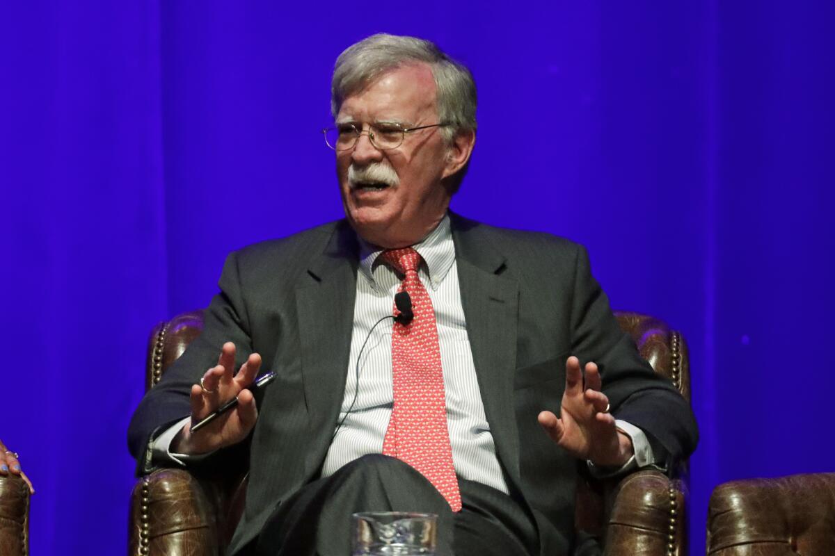 John Bolton sitting in a chair