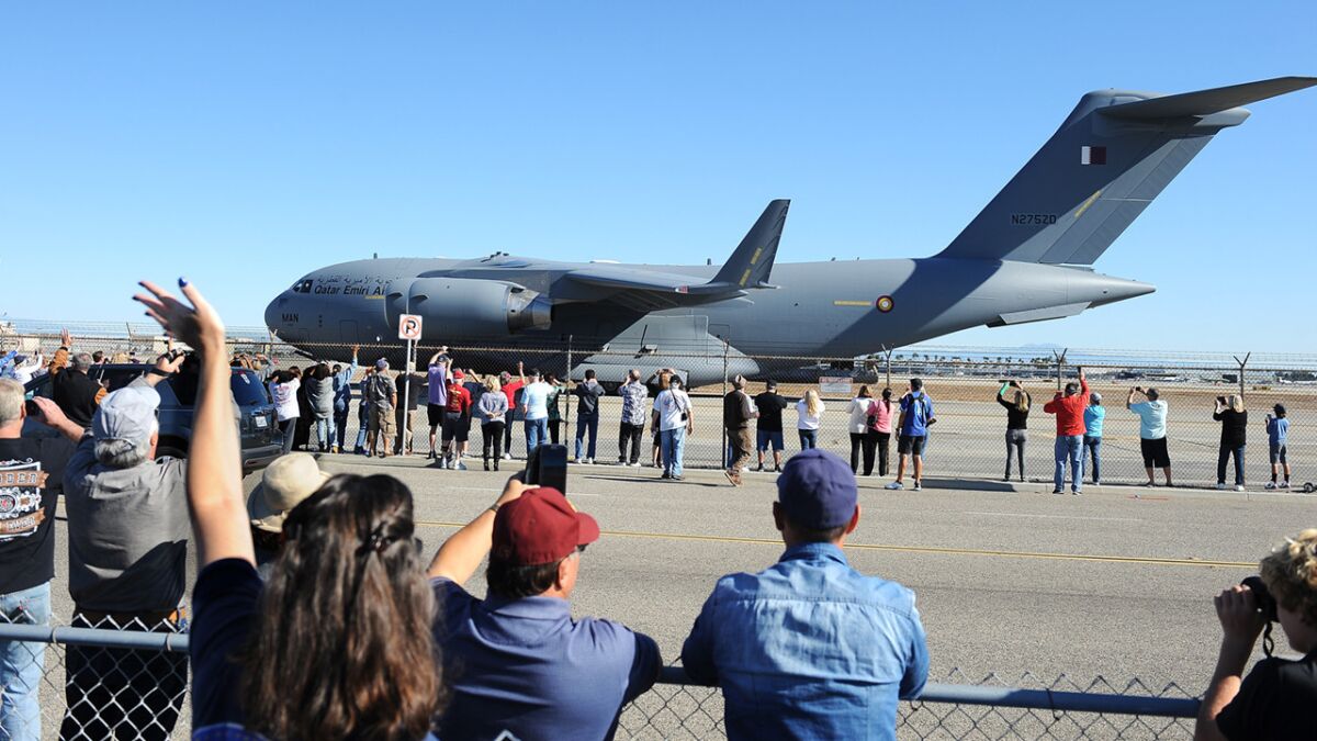 A crowd watches as the final Boeing C-17 Globemaster III cargo plane built at the company's Long Beach plant taxis at the Long Beach Airport before departure on Sunday.