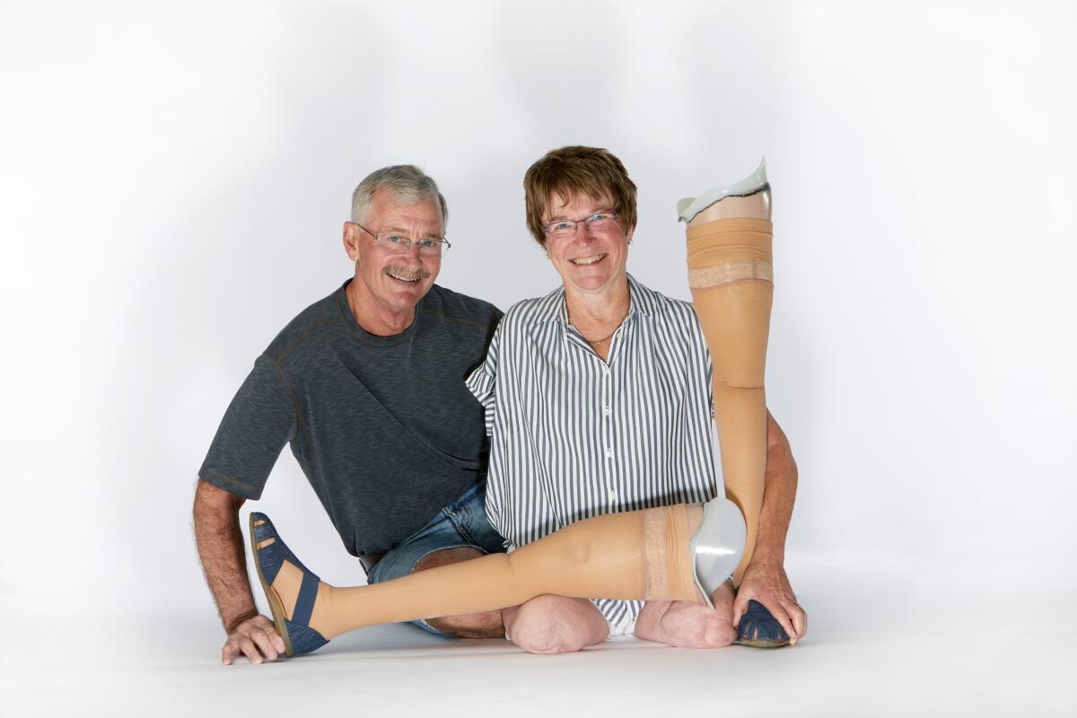 Linda Olson, right, pictured with husband David Hodgens, said the message of her book is 'get out and go.'
