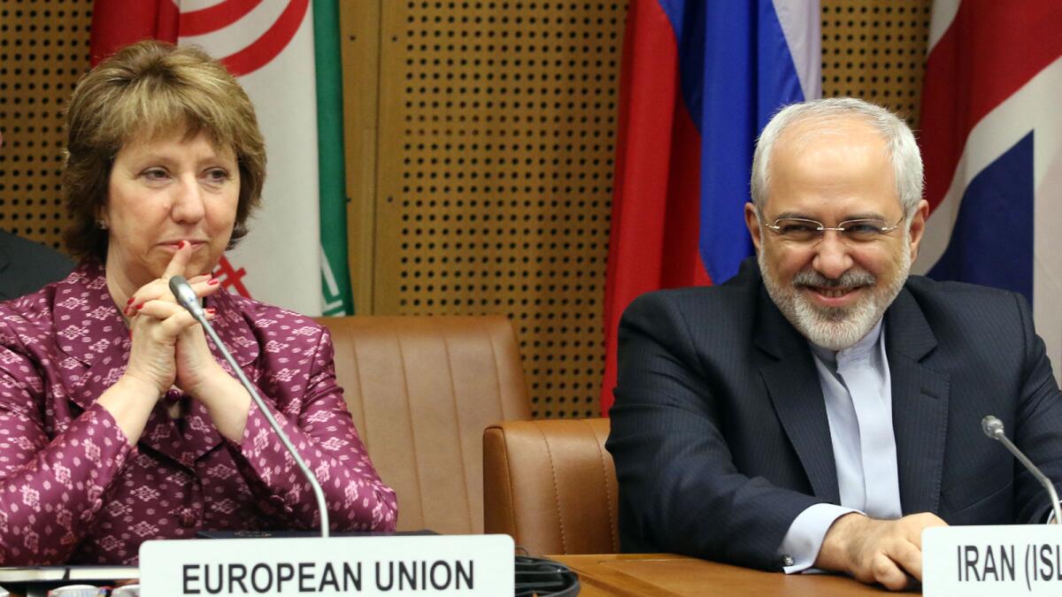 European foreign policy chief Catherine Ashton, left, and Iranian Foreign Minister Mohammad Javad Zarif, right, wait for the start of closed-door nuclear talks in Vienna earlier this month.