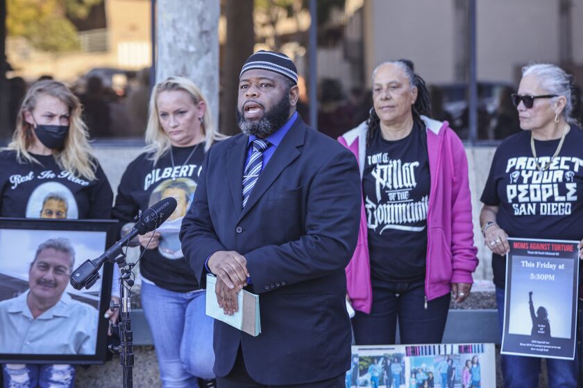 San Diego, CA - January 25: Surrounded with families who lost loved ones, Yusef Miller, of the Racial Justice Coalition, speaks about jail deaths at San Diego County Sheriff's headquaters on Wednesday, Jan. 25, 2023 in San Diego, CA. (Eduardo Contreras / The San Diego Union-Tribune)