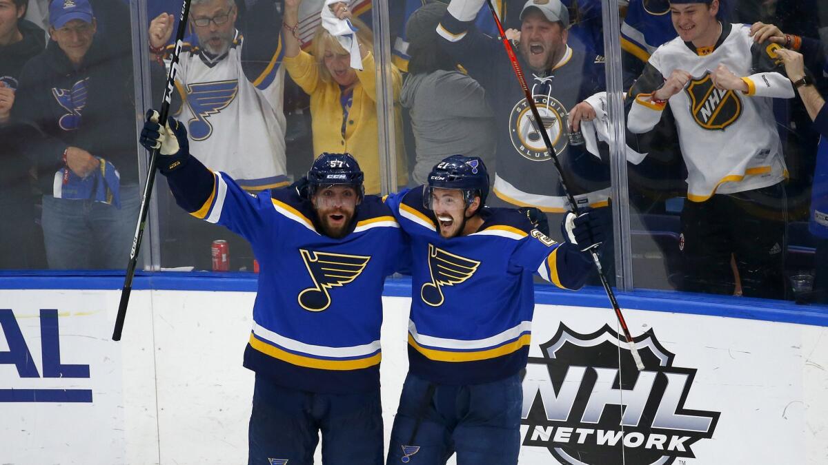 St. Louis Blues' Tyler Bozak (21) celebrates with David Perron (57) after scoring a goal against the San Jose Sharks during the third period in Game 6 of the Western Conference finals during the NHL playoffs on Tuesday.