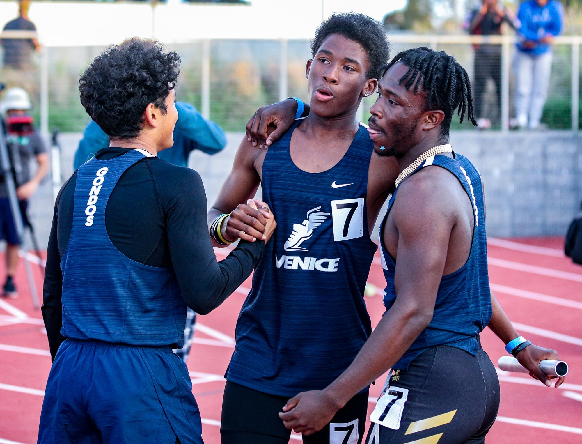Nathan Santa Cruz (7) is congratulated by Venice teammates after his anchor leg in the 4x400 relay 