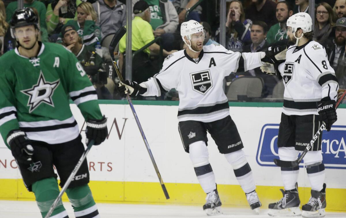 Kings center Jeff Carter celebrates his goal with teammate Drew Doughty as Dallas Stars center Jason Spezza skates off during a Dec. 23. game at American Airlines Center.