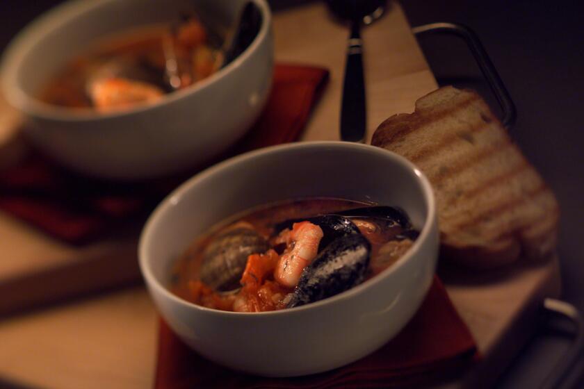 022775.FO.0117.food6.AR SOS: Sicily Italian Kitchen Cioppino. Bowls, napkins and boards from Crate & Barrel stores.