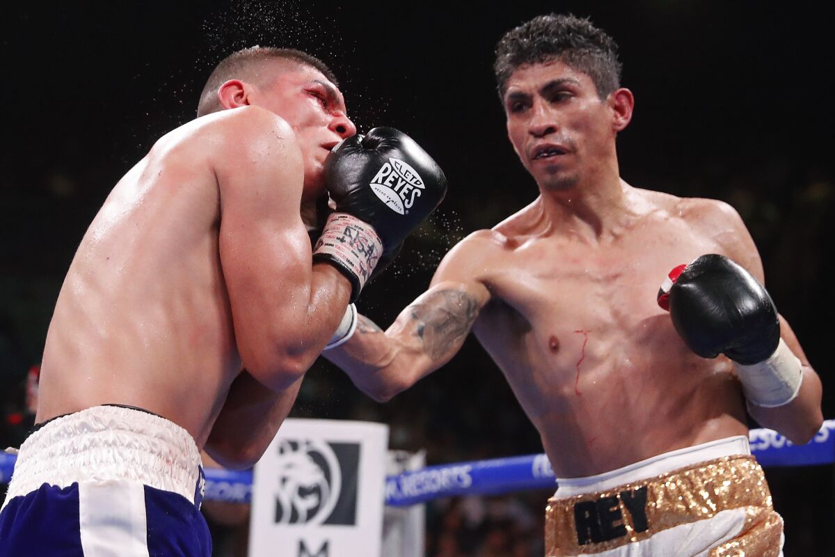 Rey Vargas connects with a right to the body of Leonardo Baez during their featherweight match Saturday.