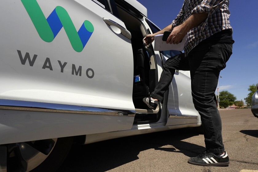 FILE - In this April 7, 2021 file photo, a Waymo minivan arrives to pick up passengers for an autonomous vehicle ride, in Mesa, Ariz. Waymo, the self-driving car pioneer spun off from Google, isn't allowing a recent wave of executive departures to detour its plans to expand its robotic taxi service. The Mountain View, Calif., company made that clear Wednesday, June 16 by announcing it has raised another $2.5 billion from a group of investors ranging from venture capital firms such as Andreessen Horowitz to a major car dealer, AutoNation. (AP Photo/Ross D. Franklin, File)