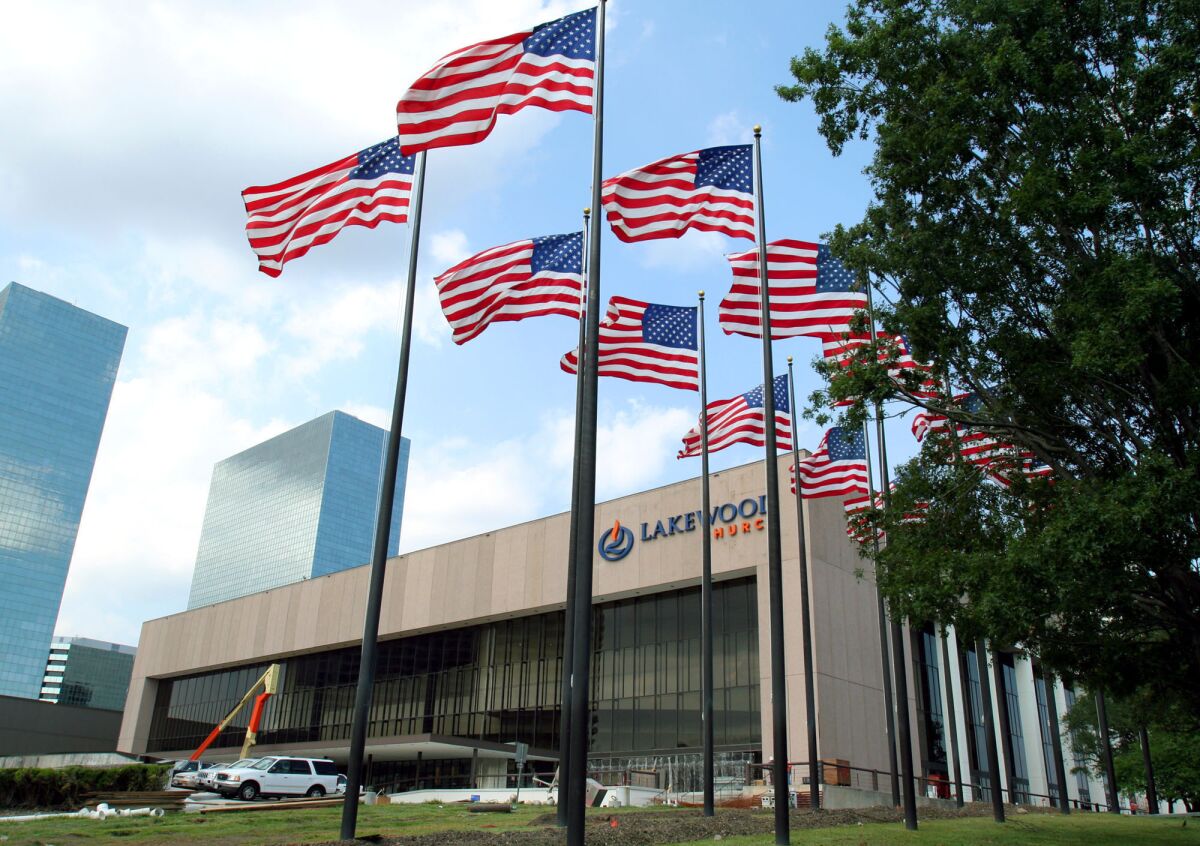FILE - Flags fly in front of the Lakewood Church June 28, 2005 in Houston. Authorities are investigating whether cash and checks discovered during repair work being done at Pastor Joel Osteen’s Houston megachurch is connected to $600,000 that was stolen from a church safe more than seven years ago. (AP Photo/Pat Sullivan File)