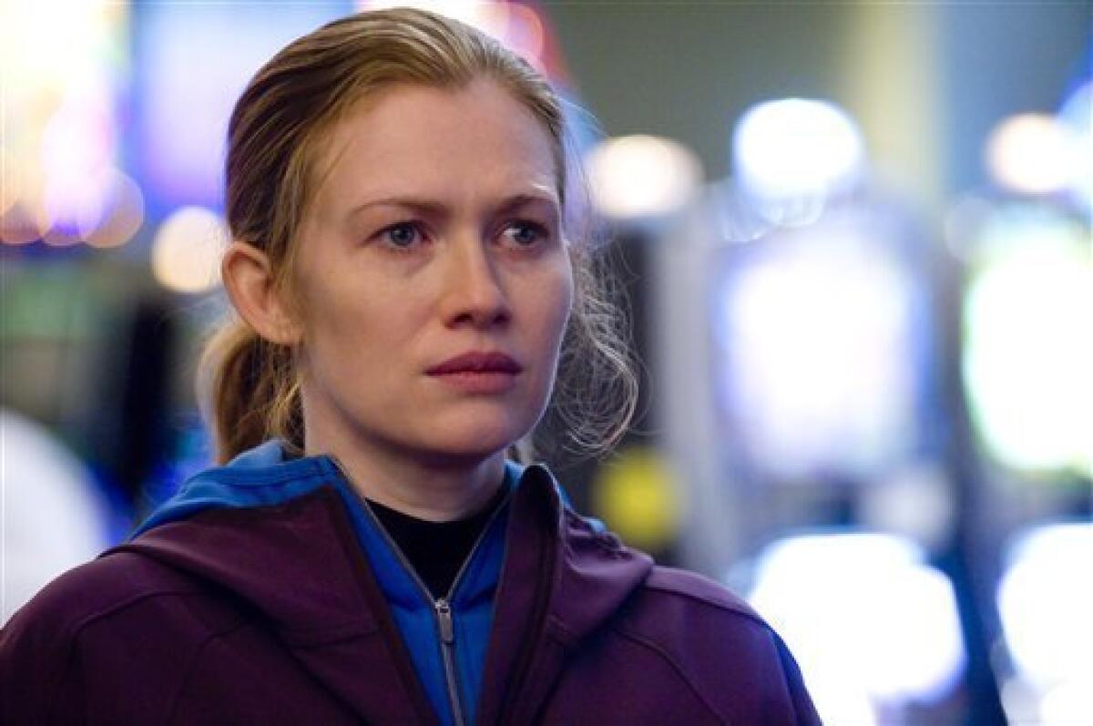 In this publicity image released by AMC, Mireille Enos is shown in a scene from "The Killing." Enos plays Seattle Homicide Detective Sarah Linden, who, through the AMC drama's 13-episode season, is investigating a grisly case: the drowning murder of a local teenager named Rosie Larsen. (AP Photo/AMC, Carole Segal)