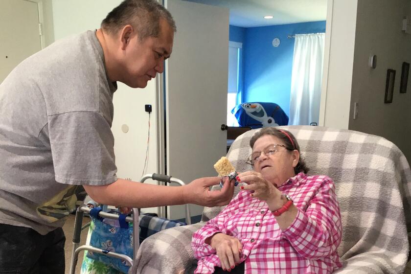 Shirley Madden depends on help from Felix Valbuena to live independently at home in Chatsworth, California. Gov. Gavin Newsom’s proposed state budget would reduce the number of hours caregivers can work under the state’s In-Home Supportive Services program.