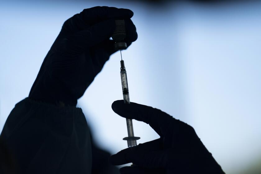 FILE - A medical staff member prepares the Pfizer COVID-19 vaccine at Tudor Ranch in Mecca, Calif., on Jan. 21, 2021. In a statement Sunday, Nov. 28, 2021, California's public health officer, Dr. Tomas J. Aragon, said that officials are monitoring the Omicron variant. There are no reports to date of the variant in California, the statement said. Aragon said the state was focusing on ensuring its residents have access to vaccines and booster shots. (AP Photo/Jae C. Hong, File)