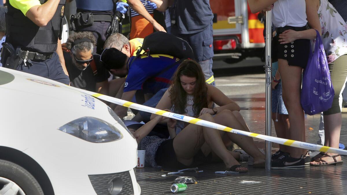 Victims receive aid in Barcelona, Spain, where a van mowed down pedestrians on Las Ramblas street last month by veering into the crowds.