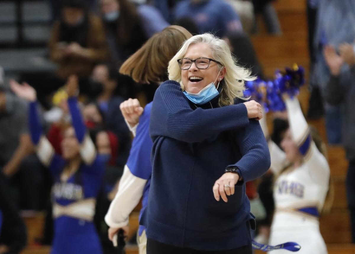Fountain Valley coach Marianne Karp celebrates after defeating Corona del Mar during a girls' Surf League basketball game.