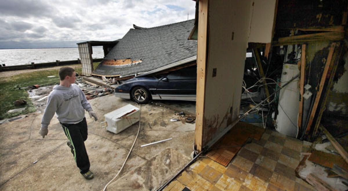 Freddie Nocella Jr. helps to salvage belongings from his grandparents' heavily damaged home in the aftermath of super storm Sandy in Babylon Village, N.Y.