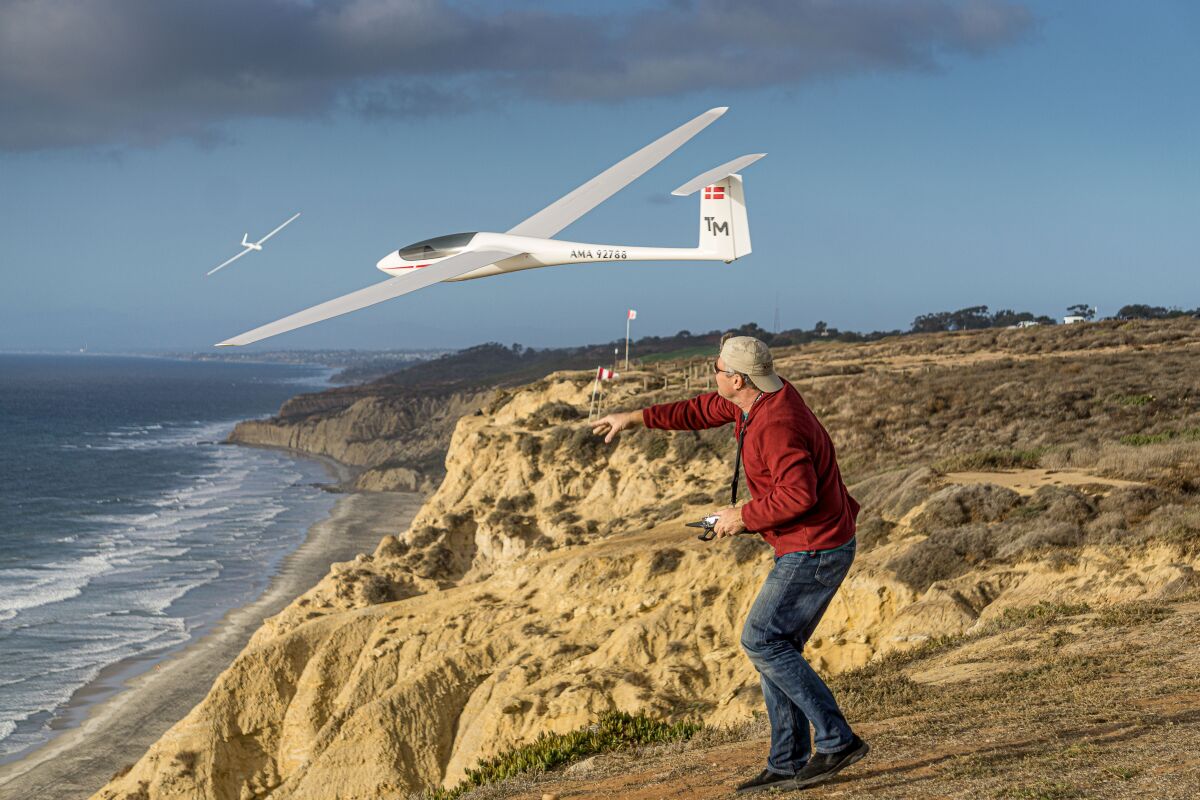 Gulls member Thomas Moller launches his 4-meter ASH-26 scale sailplane off the cliff at the Torrey Pines Gliderport.