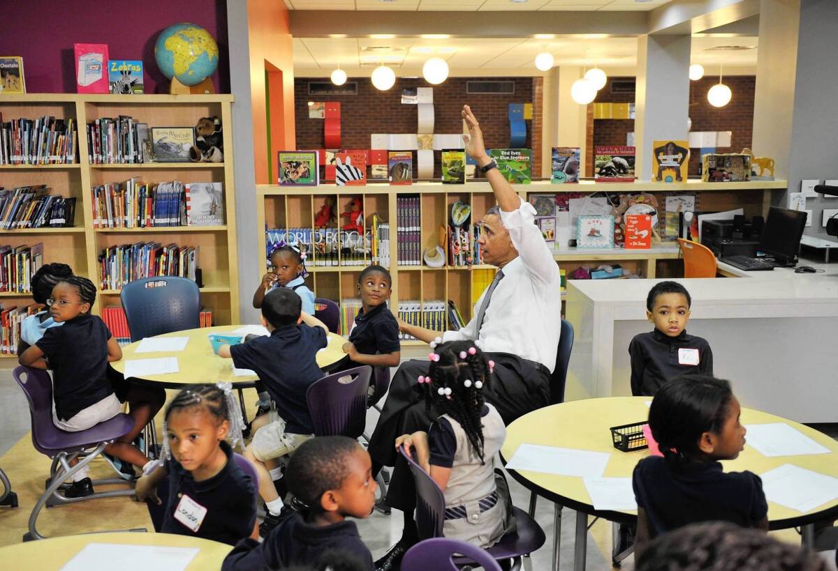President Obama raises his hand with a question during a visit to a pre-kindergarten class in Baltimore. On his trip to a manufacturing plant in the city, the president hoped to turn public attention to job creation efforts.