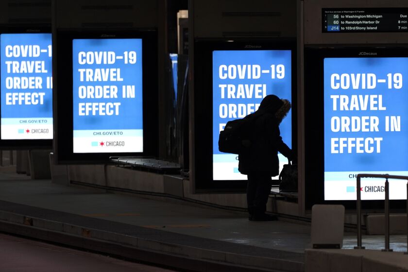 Public service signs at a Chicago bus stop urge people to stay home to halt the spread of COVID-19.
