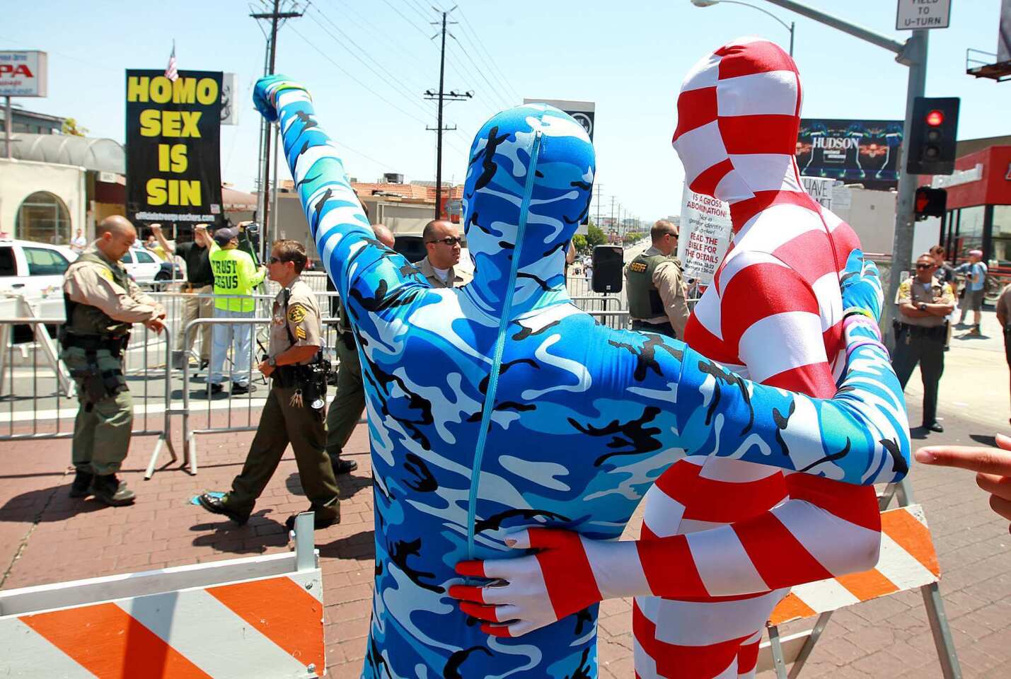 2012 L.A. Pride Parade: Parade goers stop to protest an anti-gay group preaching on Santa Monica Boulevard during the L.A. Pride Parade in West Hollywood on Sunday.