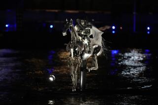 An artist performs in Paris, France, during the opening ceremony of the 2024 Summer Olympics, Friday, July 26, 2024. (AP Photo/Luca Bruno)