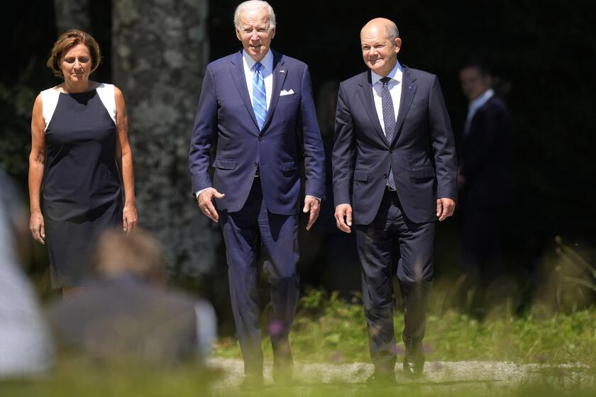 German Chancellor Olaf Scholz, right, and U.S. President Joe Biden, center, arrive for the official G7 summit welcome ceremony at Castle Elmau in Kruen, near Garmisch-Partenkirchen, Germany, on Sunday, June 26, 2022. The Group of Seven leading economic powers are meeting in Germany for their annual gathering Sunday through Tuesday. (AP Photo/Martin Meissner)