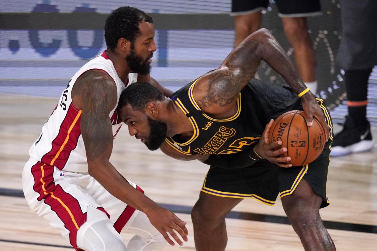 Lakers forward LeBron James tries to clear some space from Heat forward Andre Iguodala during Game 2.