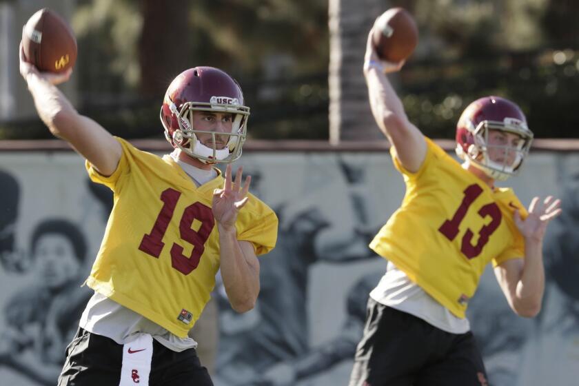 LOS ANGELES, CA, TUESDAY, MARCH 6, 2018 - Quarterbacks Matt Fink, 19, and Jack Sears, 13, at Trojans Spring football practice at USC Howard Jones Field. (Robert Gauthier/Los Angeles Times)