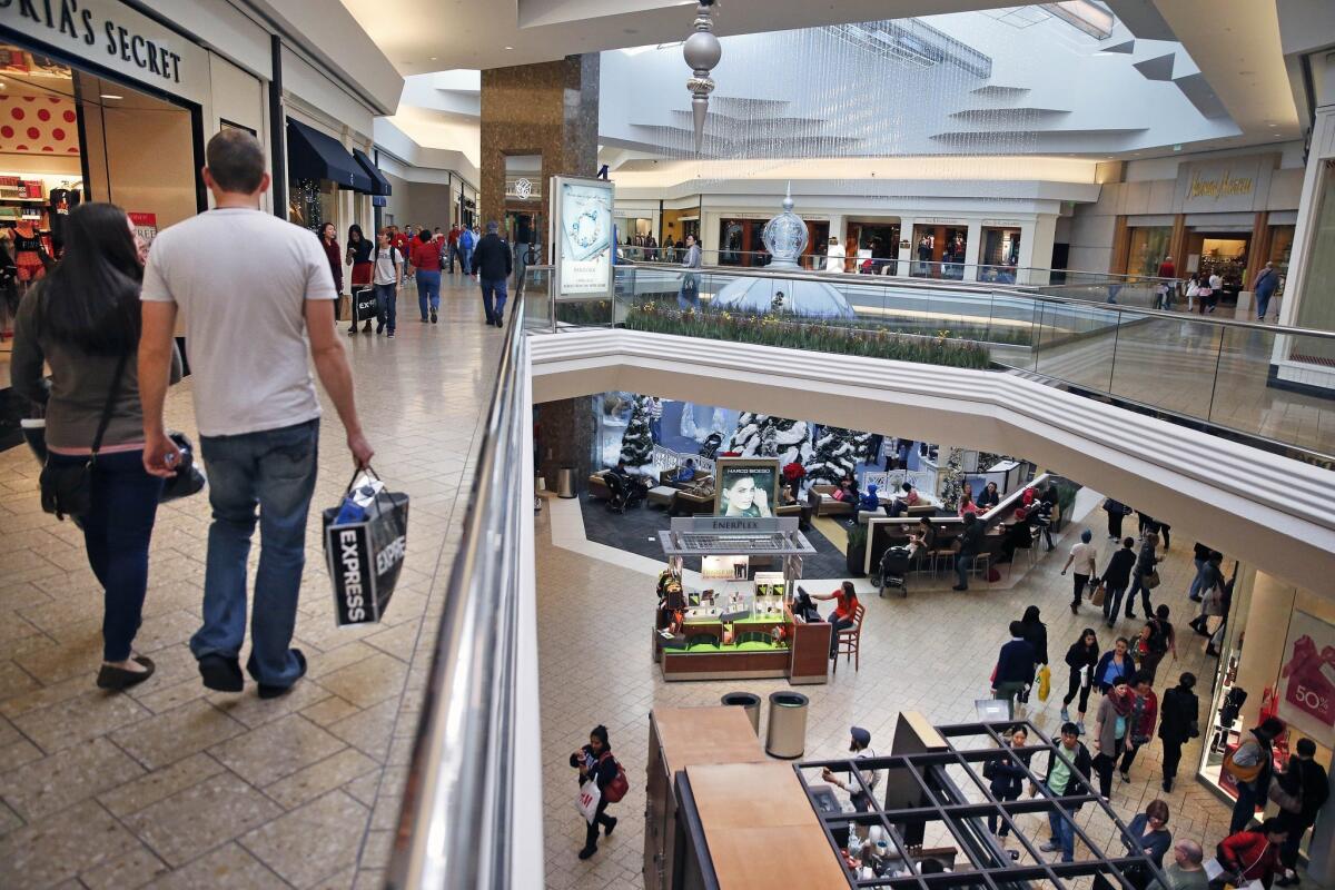 Shoppers stroll through Cherry Creek Mall in Denver. The latest reports showed consumer spending rose at a healthy rate in August 2015.