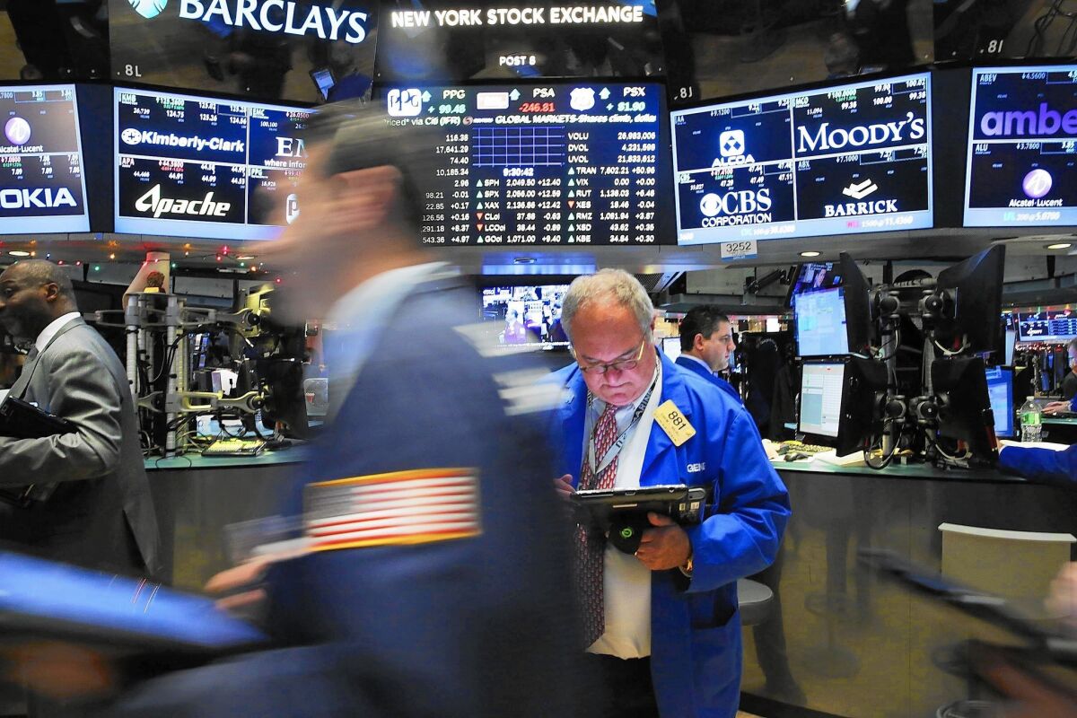 The Dow Jones industrial average slipped 2.2% for the year after falling 178.84 points on Thursday to close at 17,425.03. It was the Dow’s first annual loss since the crash year of 2008. Above, traders at the NYSE.