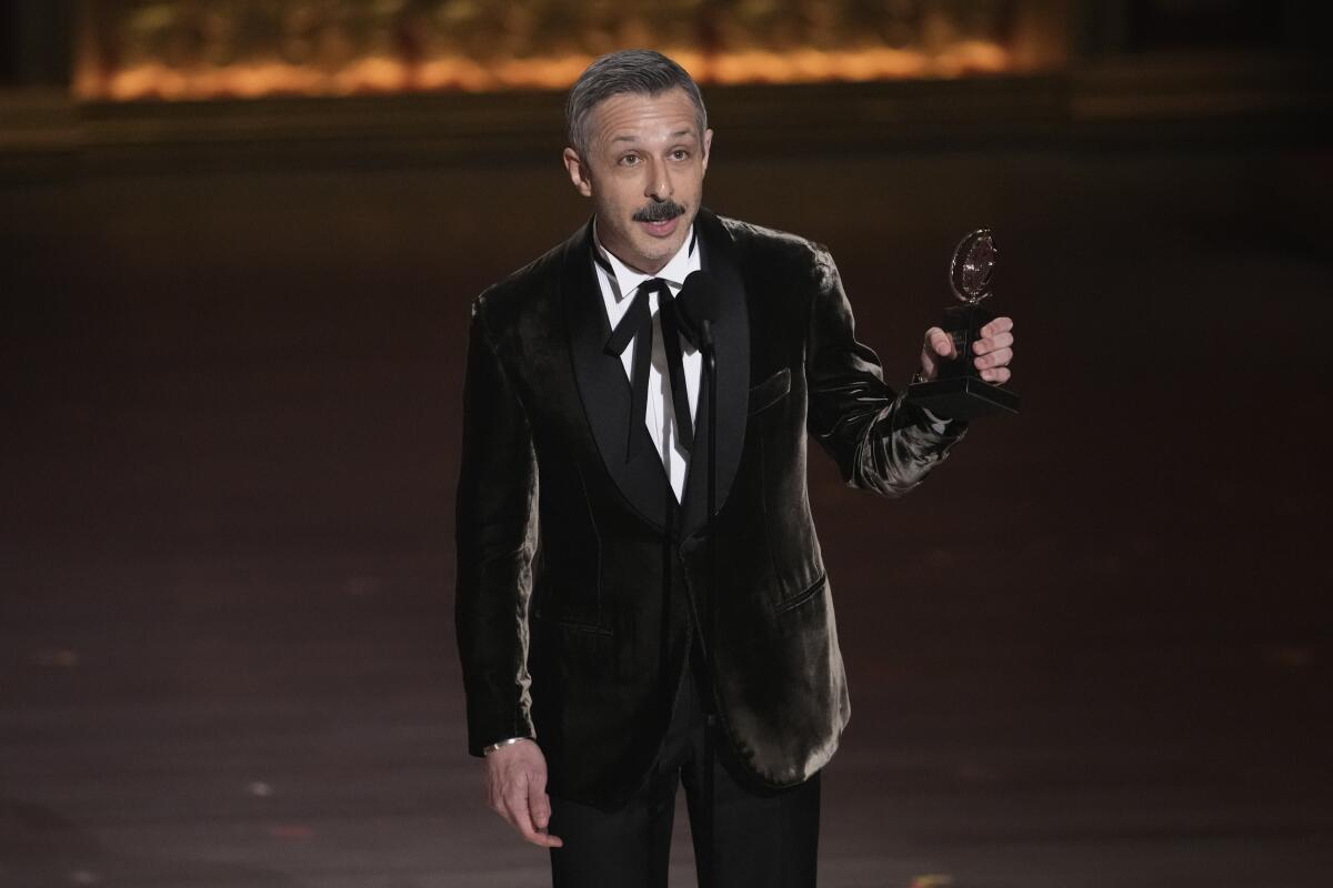 Jeremy Strong accepts a Tony Award statuette