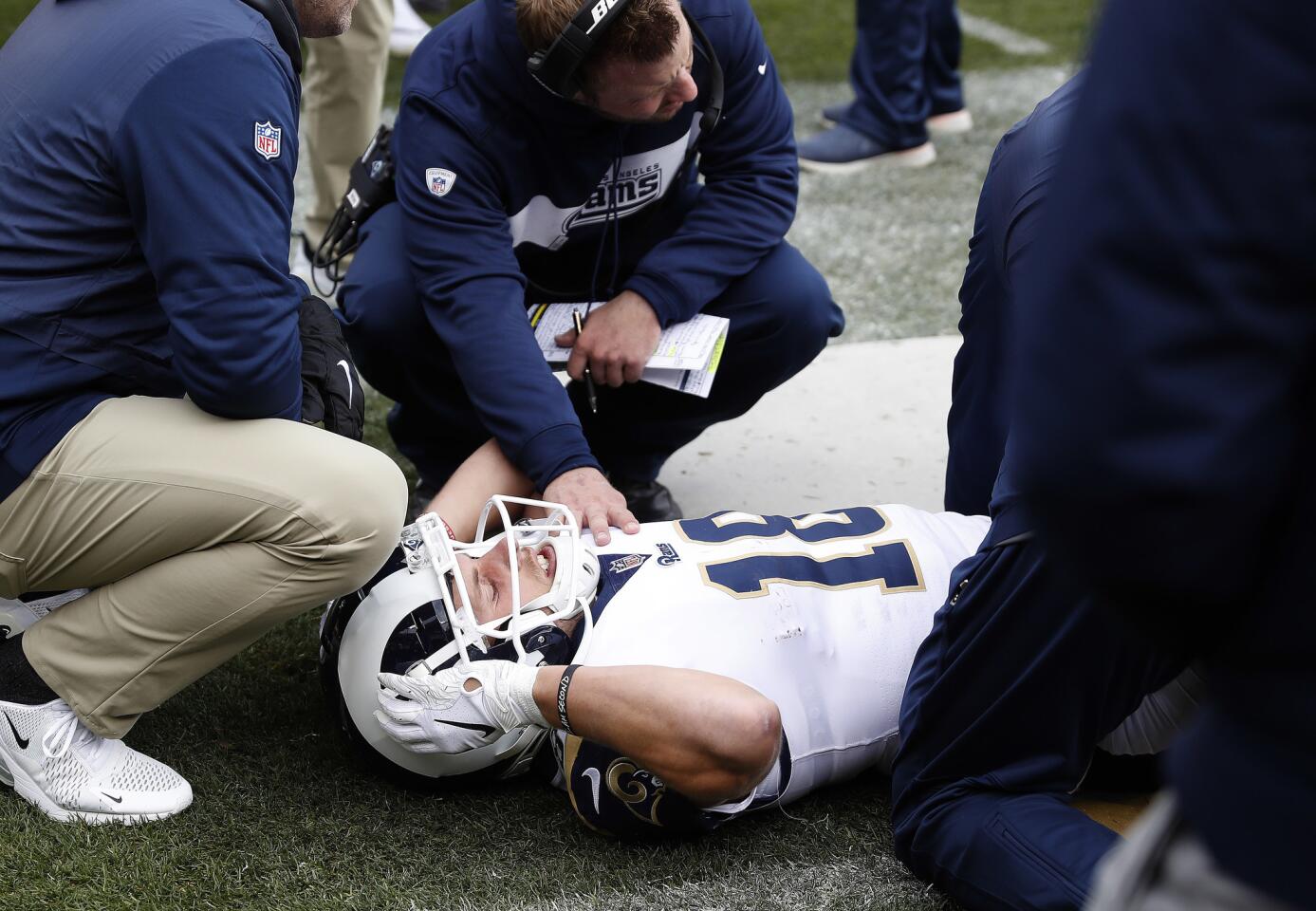 Los Angeles Rams wide receiver Cooper Kupp (18) is attended to on the sideline after an injury against the Denver Broncos during the first half of an NFL football game, Sunday, Oct. 14, 2018, in Denver.