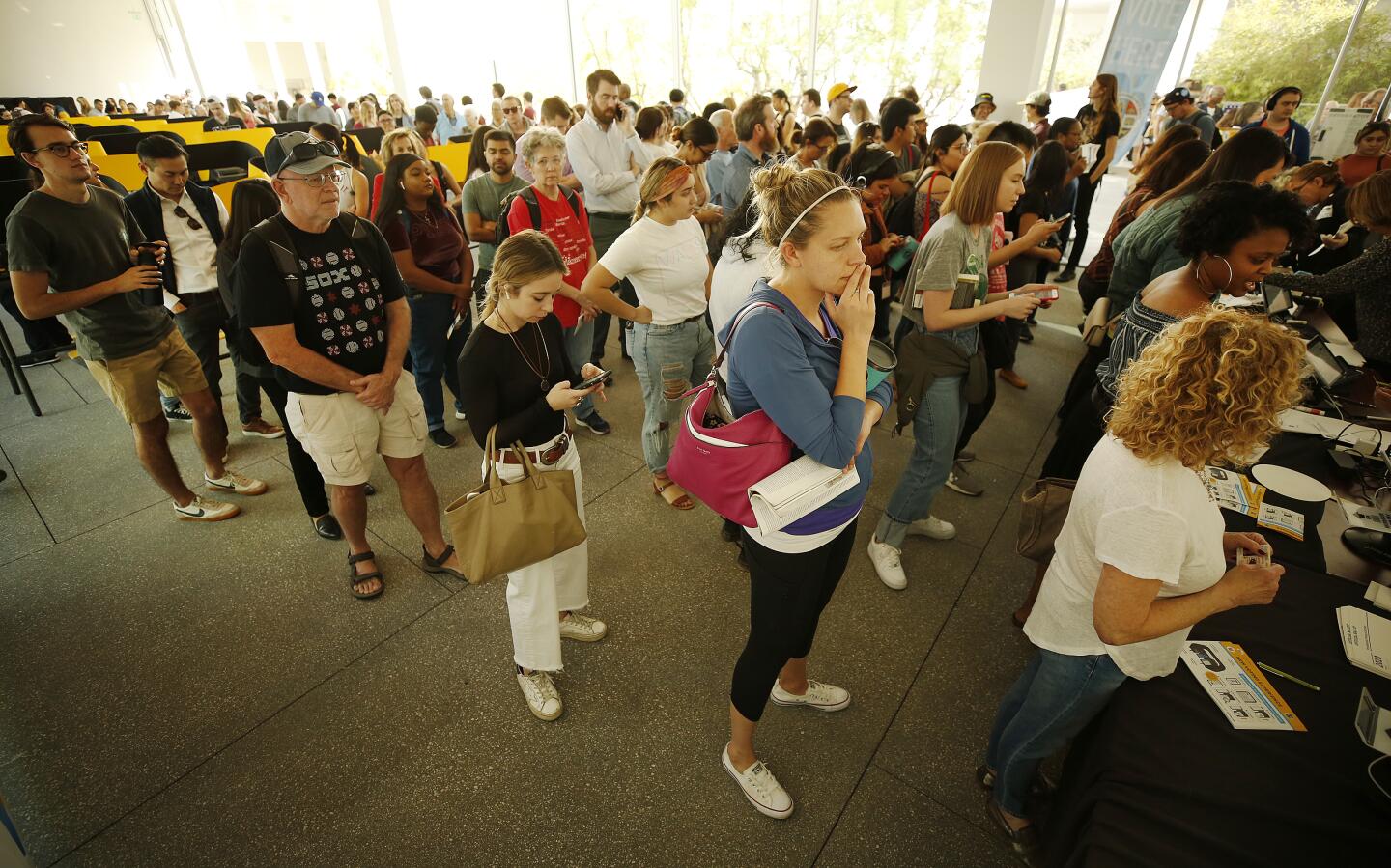 LOS ANGELES, CA - MARCH 3, 2020 Sarah Woodard, center, is almost to the check in desk as a huge line builds with people making their way up waiting almost 2 hours in a moving line before they are able to vote using the new voting machines at the UCLA Hammer Museum on Super Tuesday as people make their way to the polls March 3, 2020. (Al Seib / Los Angeles Times)