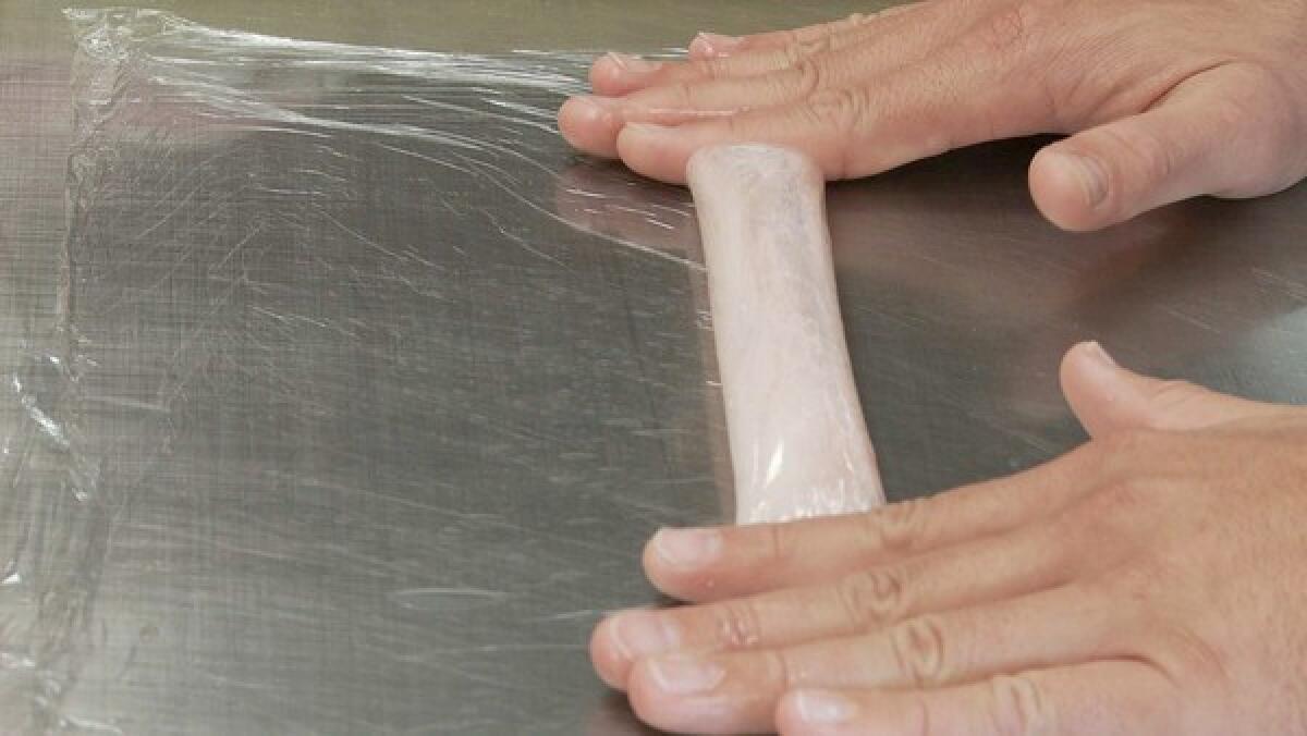 Rory Herrmann, chef de cuisine at Bouchon Bistro in Beverly Hills, Calif., demonstrates sous-vide using plastic wrap.