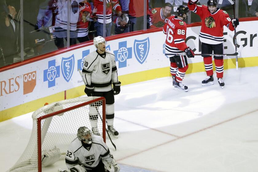 Blackhawks left wing Teuvo Teravainen (86) celebrates his goal with Patrick Kane (88) as Kings defender Christian Ehrhoff (10) watches a replay during the third period.