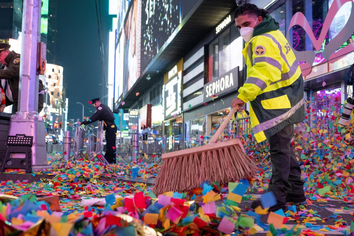 The New York City Department of Sanitation workers clean up confetti and trash after New Year’s Eve in Times Square.