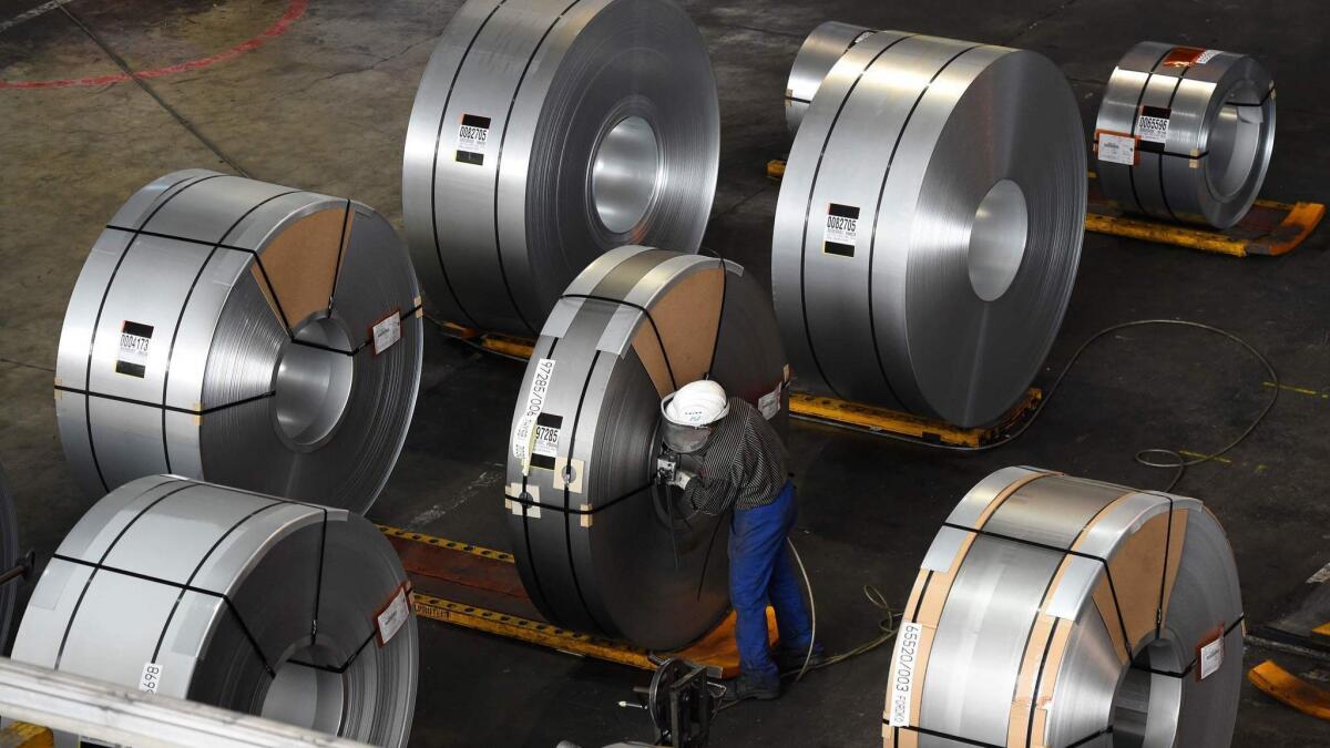 A worker packs coils for delivery at a steel production site in Germany. President Trump has imposed tariffs on steel and aluminium imports from Europe, Mexico and Canada.