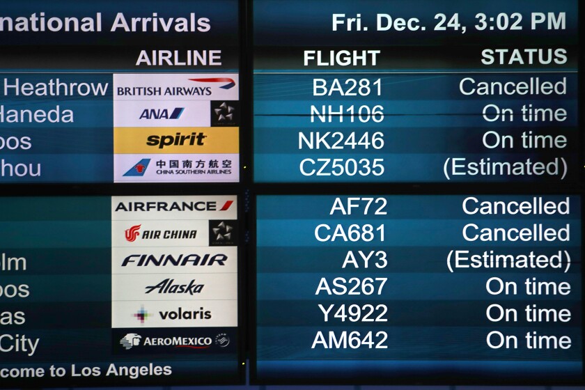 LOS ANGELES, CA. - DEC 24, 2021. Monitors at LAX show canceled flights on Friday, Dec. 24, 2021. The Omicron variant of the coronavirus has swept across the world as millions of travelers are on the move for the holidays. Thousands of flights worldwide were canceled on Friday because of the fast-spreading virus. (Luis Sinco / Los Angeles Times)