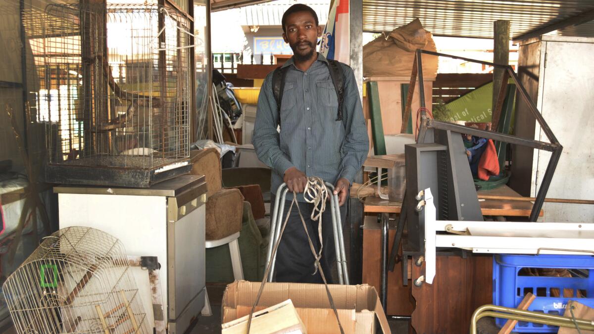 Sandile Mavimbela's bookshop consists of a plastic sheet, laid out on a sidewalk in Johannesburg, and a battered trolley with cardboard boxes that he uses to drag his books home at night.