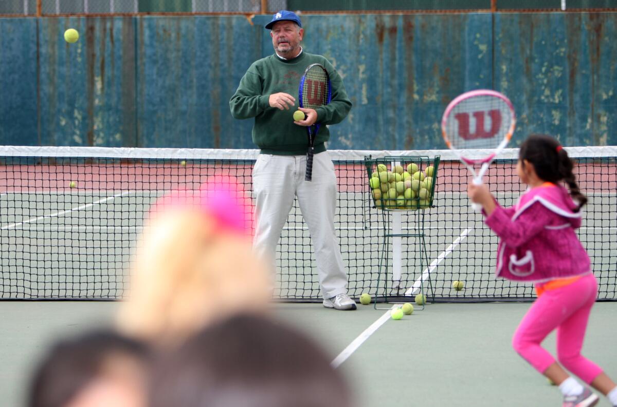 Tennis coach Joe Steckermeier, who has been teaching tennis to children and youth for 30 years at the Community Center of La Cañada Flintridge, works with some of his students at the tennis courts in La Cañada Flintridge, on Wednesday, May 25, 2016.
