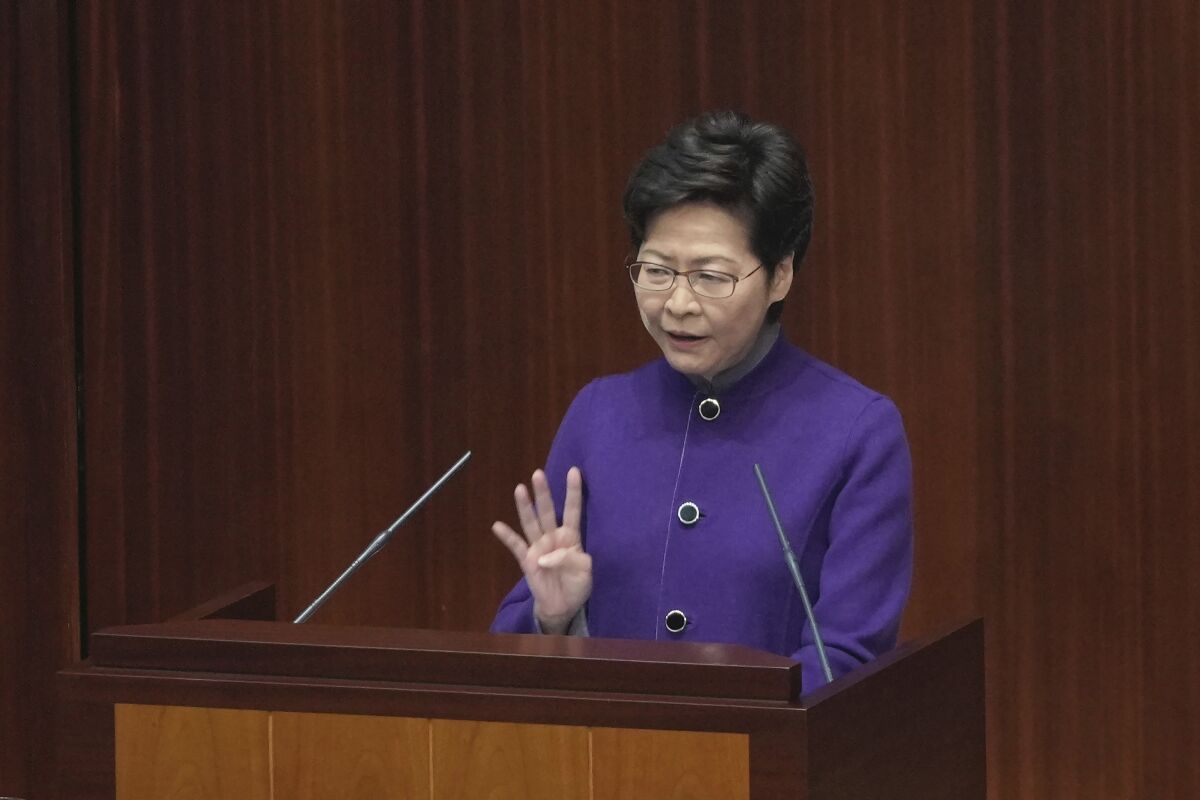Hong Kong Chief Executive Carrie Lam speaks during a question and answer session at the Legislative Council in Hong Kong, Wednesday, Jan. 12, 2022. Hong Kong’s local legislature convened Wednesday for the first time since elections last month held under new legislation ensuring that only “patriots” who have proven their loyalty to China’s central government could run as candidates. (AP Photo/Kin Cheung)