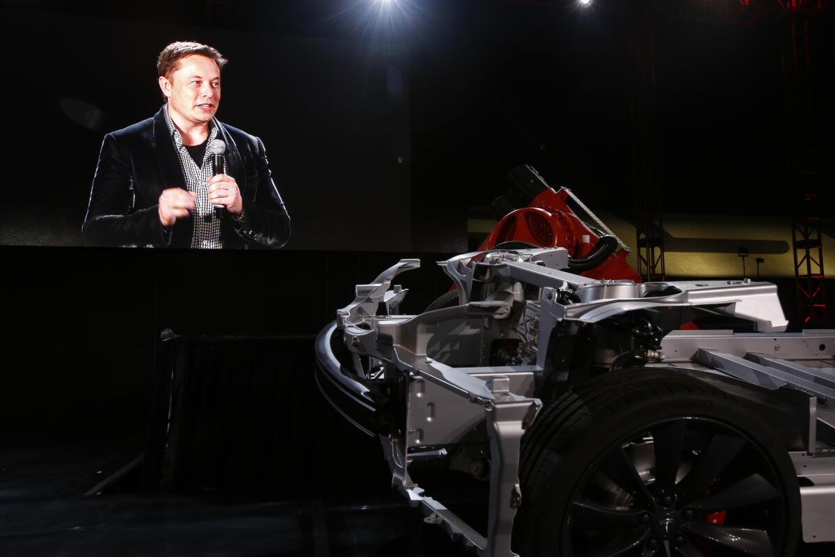 CEO Elon Musk announces a dual motor version of the Tesla Model S sedan, the P85D, in October at the company's Hawthorne facility.