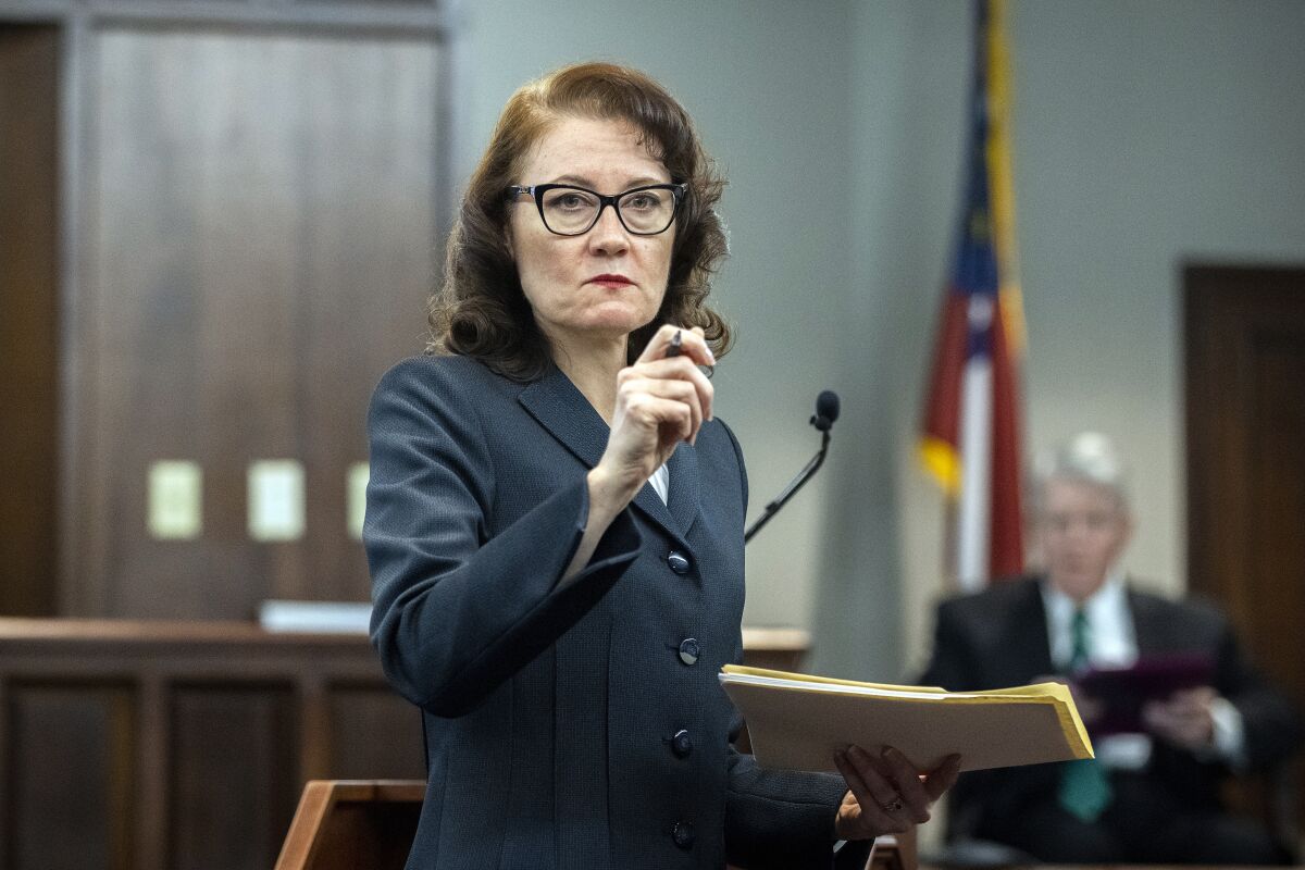 Prosecutor Linda Dunikoski asks for evidence be brought into the courtroom during Dr. Edmund R. Donoghue's testimony, in the trial of Greg McMichael and his son, Travis McMichael, and a neighbor, William "Roddie" Bryan in the Glynn County Courthouse, Tuesday, Nov. 16, 2021, in Brunswick, Ga. The three are charged with the February 2020 slaying of 25-year-old Ahmaud Arbery. (AP Photo/Stephen B. Morton, Pool)